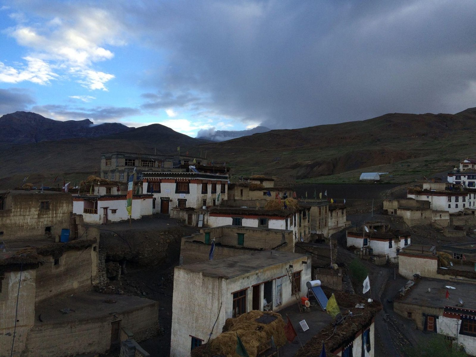 Kibber village rooftops under a stormy sky